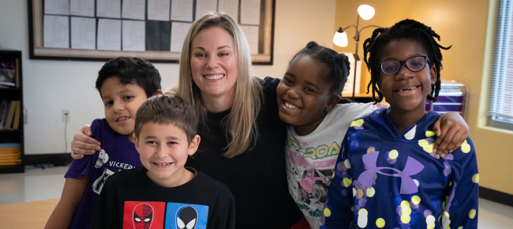 Happy teacher and joyful students in a group photo